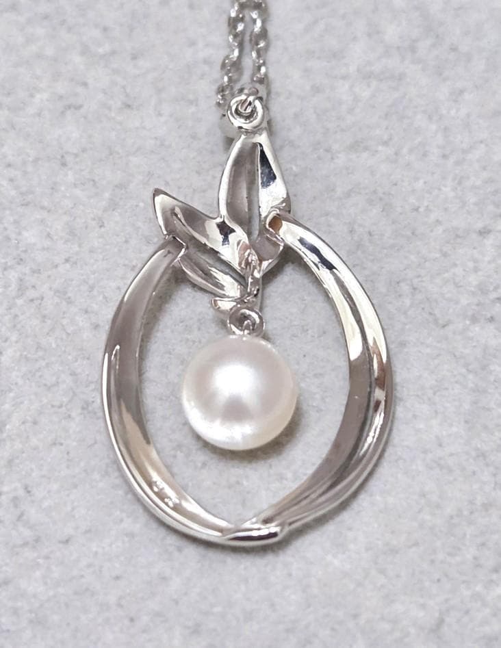 Close-up of Mikimoto 7mm pearl silver necklace with 40cm chain on a white background