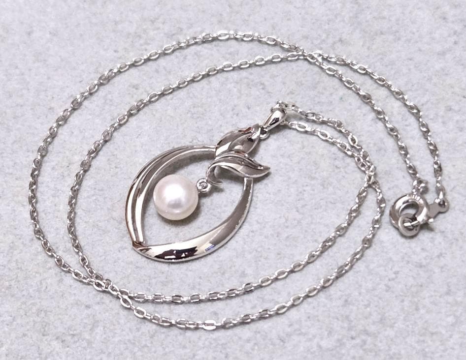 Close-up of Mikimoto 7mm pearl silver necklace with 40cm chain on a white background