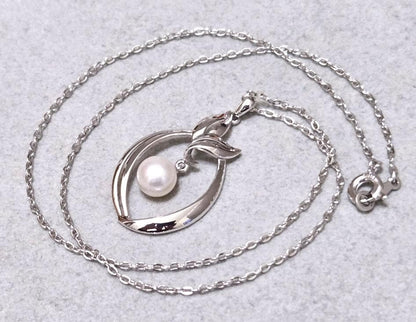 Close-up of Mikimoto 7mm pearl silver necklace with 40cm chain on a white background