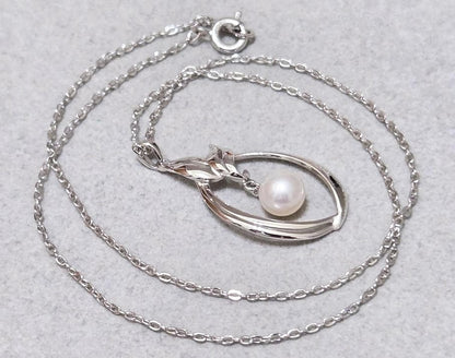 Close-up of Mikimoto 7mm pearl silver necklace with 40cm chain on a white background