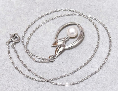 Close-up of Mikimoto 7mm pearl silver necklace with 40cm chain on a white background