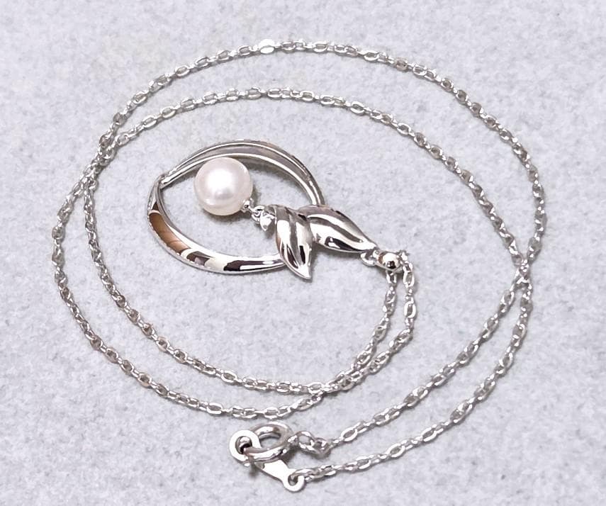 Close-up of Mikimoto 7mm pearl silver necklace with 40cm chain on a white background