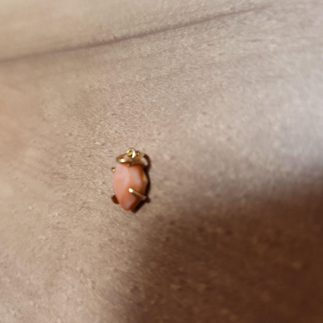 Close-up of a agete necklace charm in excellent condition with a delicate design