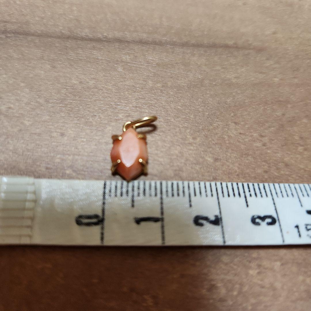 Close-up of a agete necklace charm in excellent condition with a delicate design