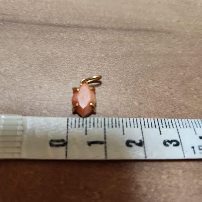 Close-up of a agete necklace charm in excellent condition with a delicate design