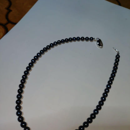 Akoya pearl necklace with blue-black pearls 6.5 to 7 mm and silver S925 clasp on white background