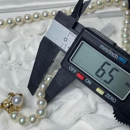 Mikimoto K18 Akoya Pearl Necklace featuring 6.5-7.0mm pearls and four diamond side stones on 44.5cm chain