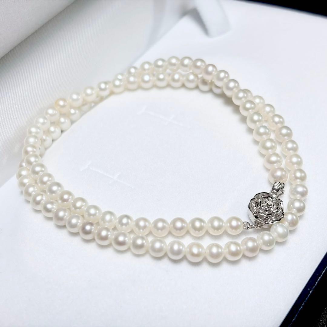 Baby Pearl Akoya genuine pearl necklace with 4.5mm pearls and silver fittings on a white background