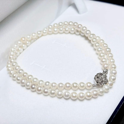 Baby Pearl Akoya genuine pearl necklace with 4.5mm pearls and silver fittings on a white background