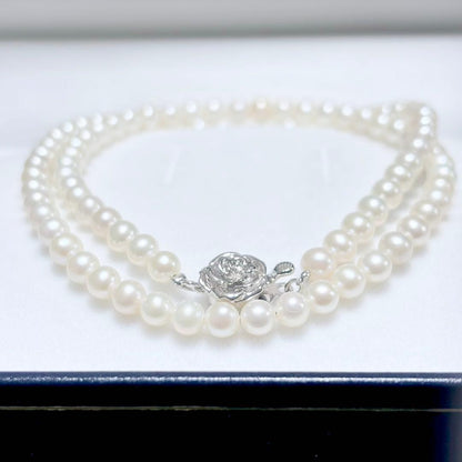 Baby Pearl Akoya genuine pearl necklace with 4.5mm pearls and silver fittings on a white background