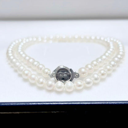 Baby Pearl Akoya genuine pearl necklace with 4.5mm pearls and silver fittings on a white background