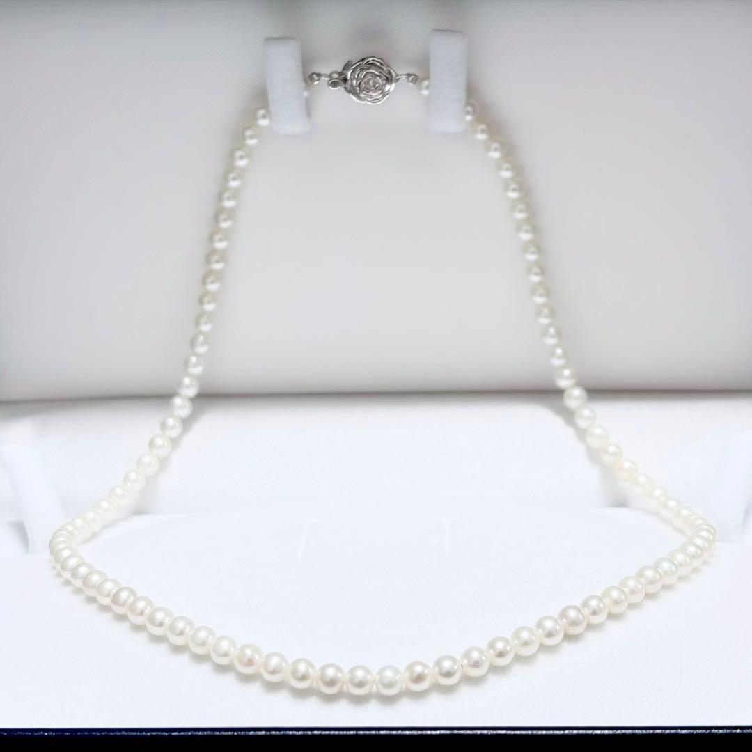 Baby Pearl Akoya genuine pearl necklace with 4.5mm pearls and silver fittings on a white background
