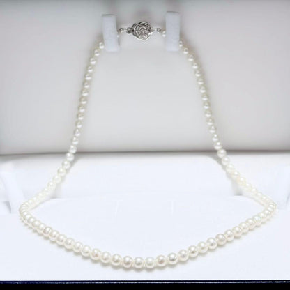 Baby Pearl Akoya genuine pearl necklace with 4.5mm pearls and silver fittings on a white background