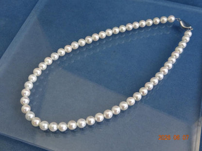 Akoya pearl necklace featuring 7.5-8mm almost round white pearls with pink, blue, and cream hues on a 43cm chain
