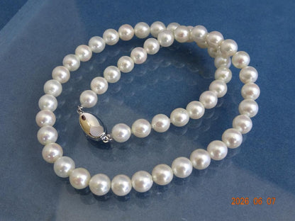 Akoya pearl necklace featuring 7.5-8mm almost round white pearls with pink, blue, and cream hues on a 43cm chain
