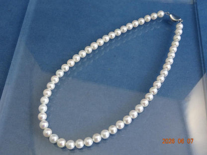 Akoya pearl necklace featuring 7.5-8mm almost round white pearls with pink, blue, and cream hues on a 43cm chain