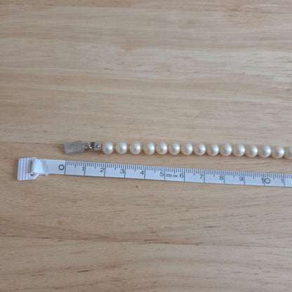 Elegant Akoya pearl necklace with white round pearls arranged in a single strand