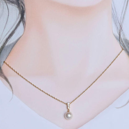 K18 yellow gold Mikimoto necklace featuring 8 mm Akoya pearl and diamond pendant measuring 1.7 cm by 0.84 cm