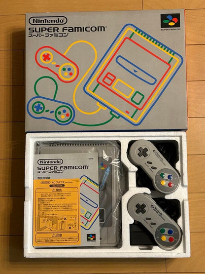 Retro SNES console with 2 controllers, AC adapter, S-VHS video cable, and 21 game cartridges including Trakia 776