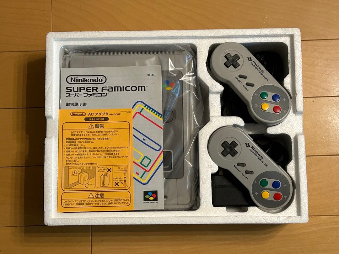 Retro SNES console with 2 controllers, AC adapter, S-VHS video cable, and 21 game cartridges including Trakia 776