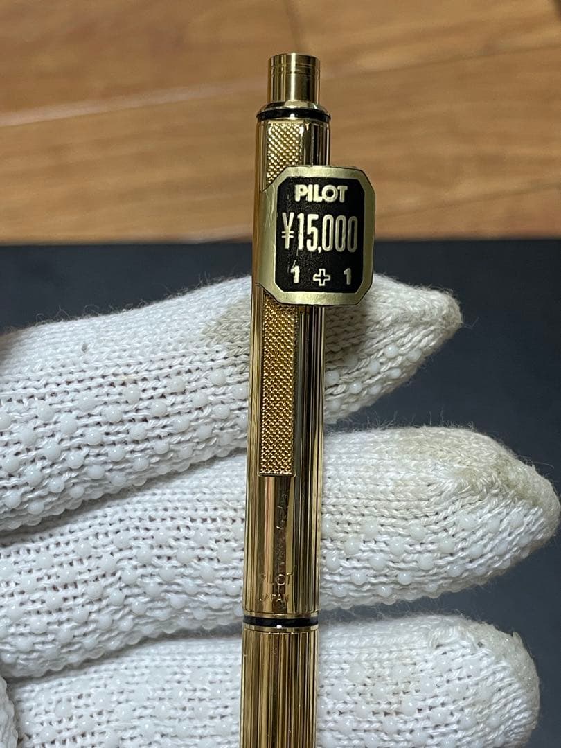 PILOT Mechanical Pencil Ballpoint Pen in gold color lying on a white background