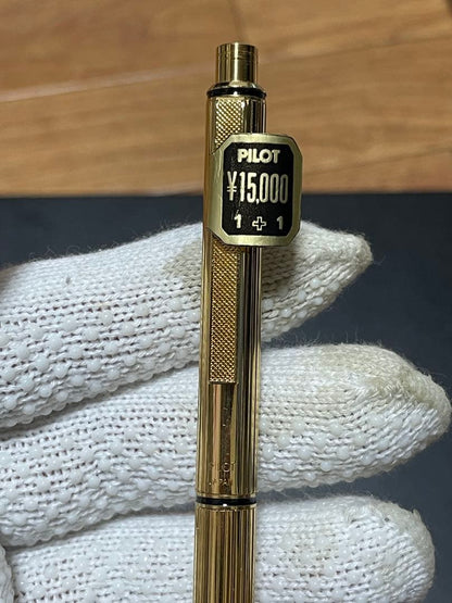 PILOT Mechanical Pencil Ballpoint Pen in gold color lying on a white background