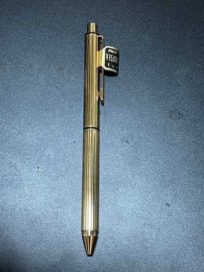 PILOT Mechanical Pencil Ballpoint Pen in gold color lying on a white background