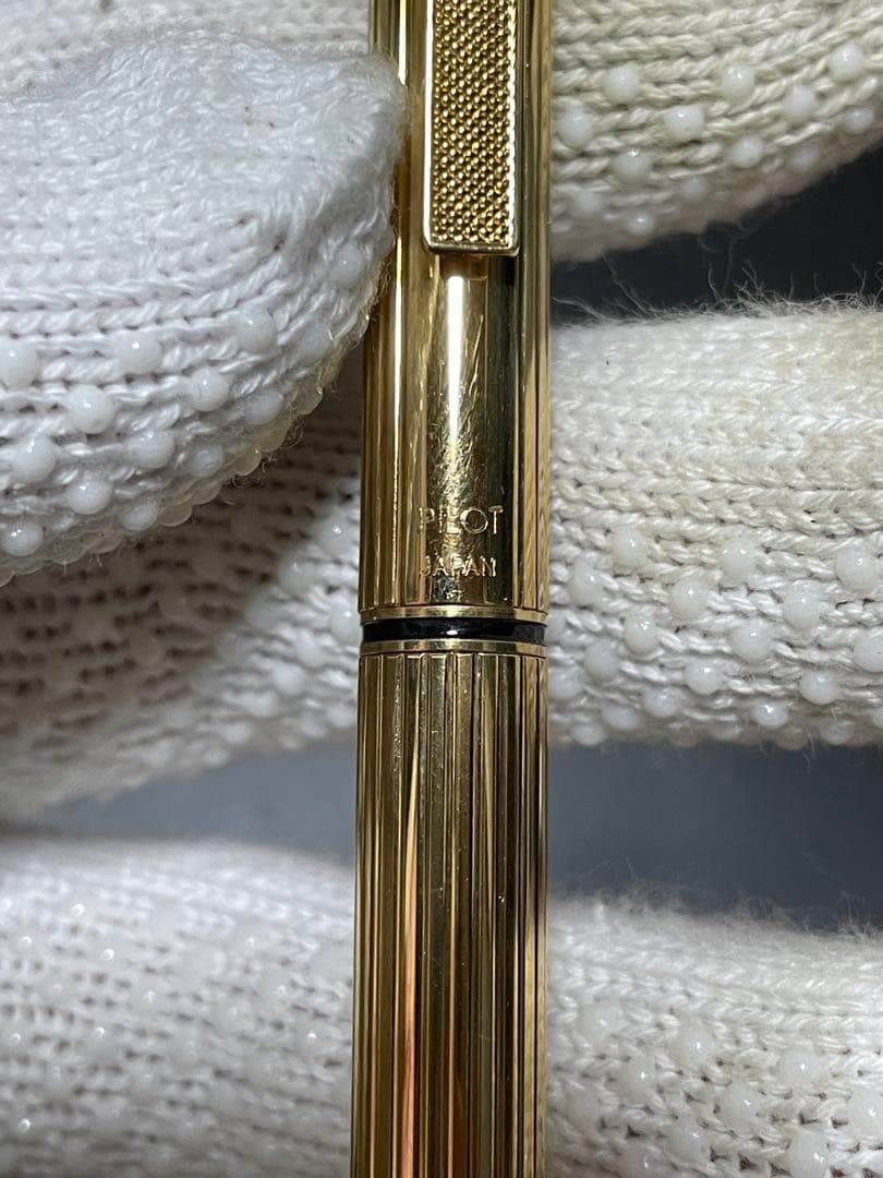 PILOT Mechanical Pencil Ballpoint Pen in gold color lying on a white background