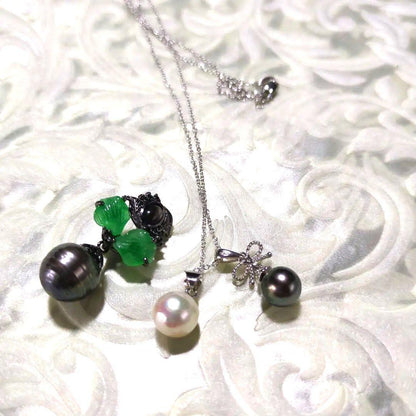 Black Akoya pearl pendant top with necklace set featuring ribbon motif and green-tinged and purple-tinged pearls