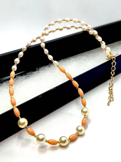 Akoya pearl and pink coral genuine pearl gold necklace with adjustable length and varying bead sizes