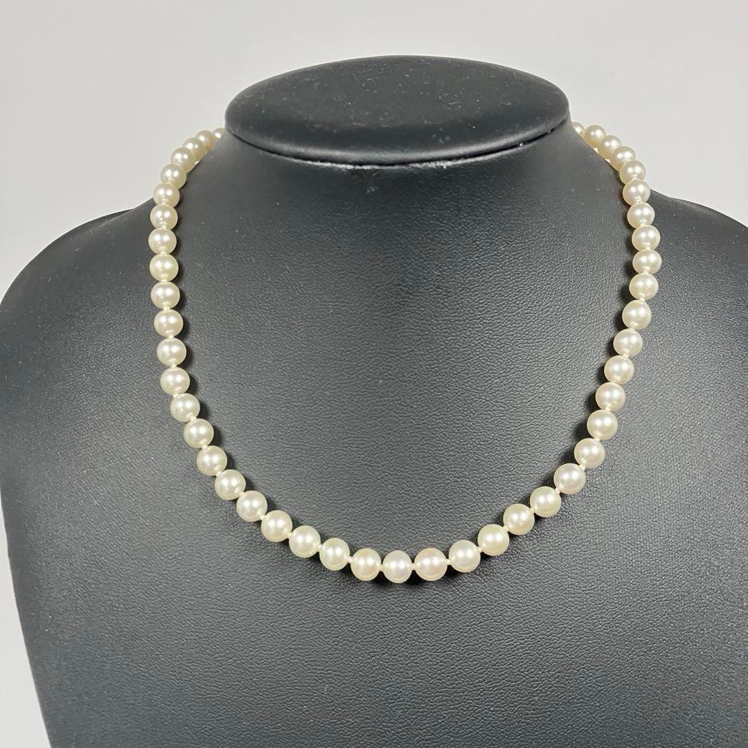 Akoya pearl necklace with 5.8 to 6.3mm pearls and silver clasp on a white background