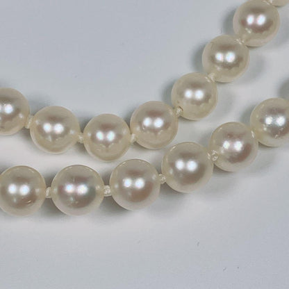 Akoya pearl necklace with 5.8 to 6.3mm pearls and silver clasp on a white background