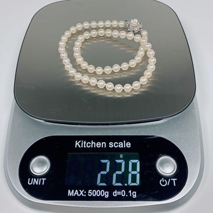 Akoya pearl necklace with 5.8 to 6.3mm pearls and silver clasp on a white background