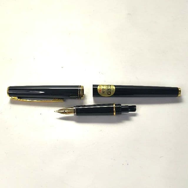 Unused PILOT fountain pen with black barrel and silver clip shown on a white background