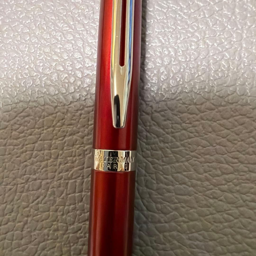 Red Waterman ballpoint pen stored in a pen case with sleek design