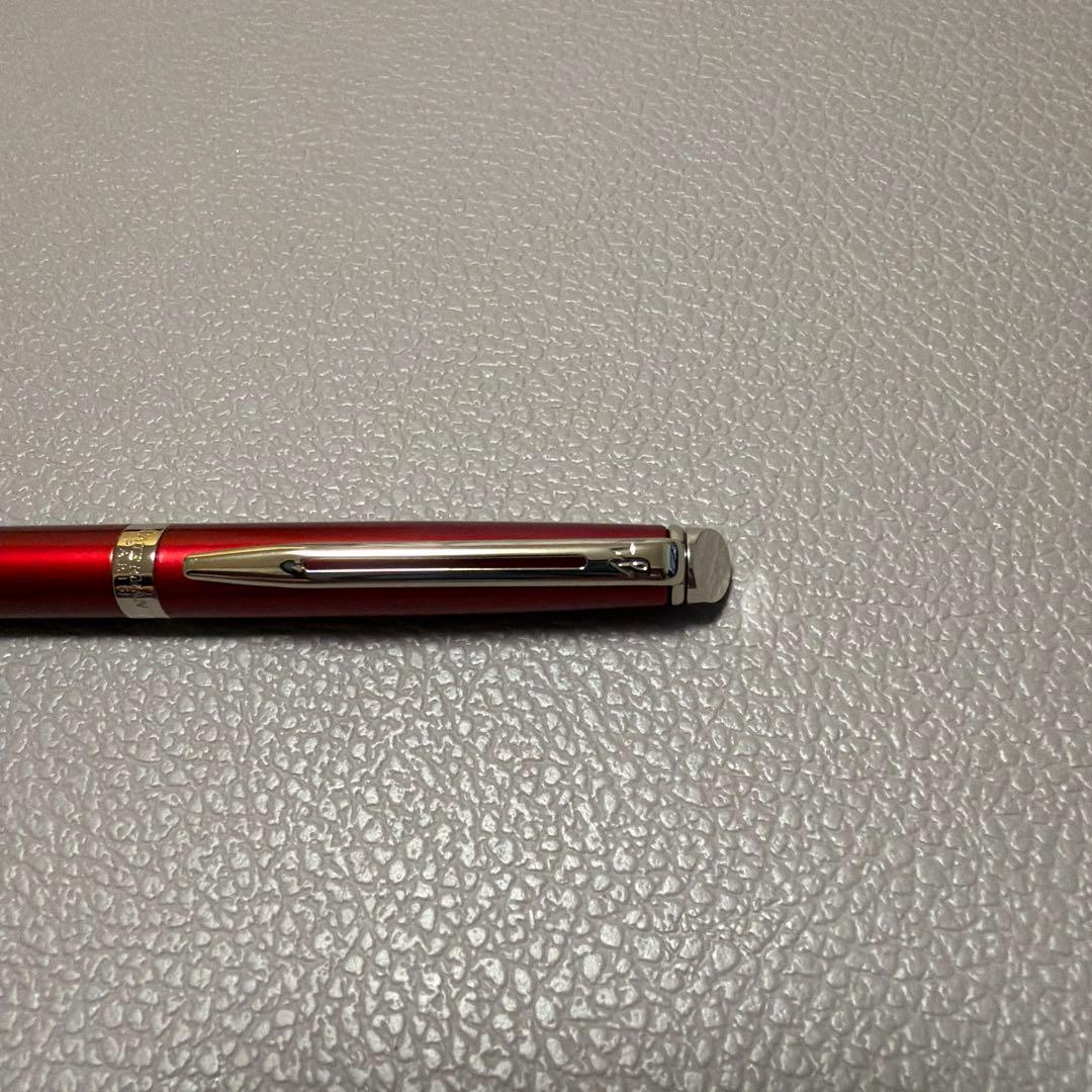 Red Waterman ballpoint pen stored in a pen case with sleek design