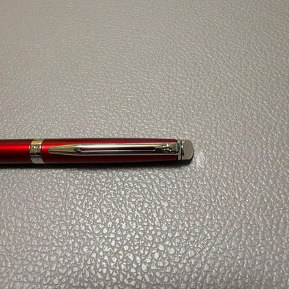 Red Waterman ballpoint pen stored in a pen case with sleek design