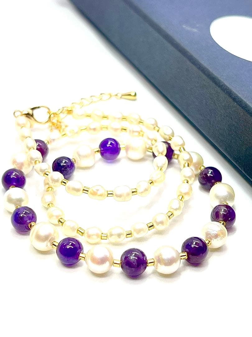 Akoya pearl and amethyst necklace with K18 gold leaf parts on a white background