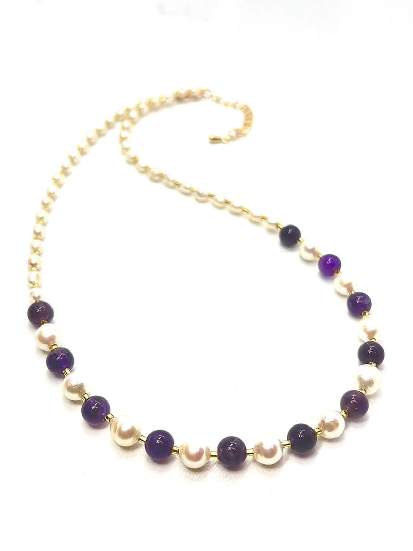 Akoya pearl and amethyst necklace with K18 gold leaf parts on a white background