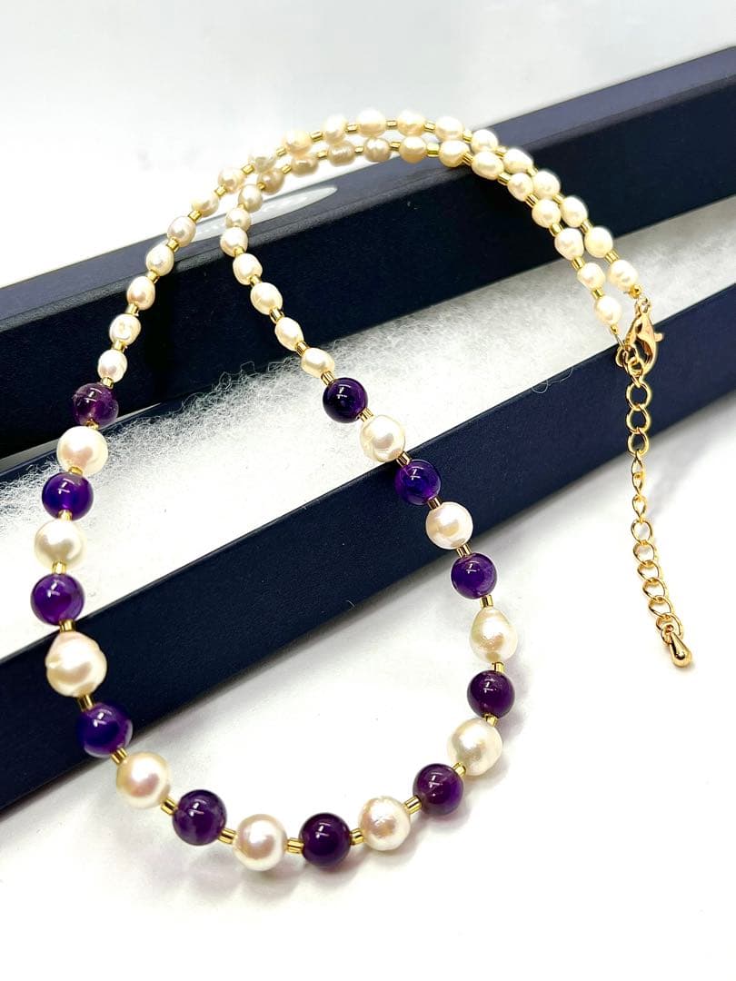 Akoya pearl and amethyst necklace with K18 gold leaf parts on a white background