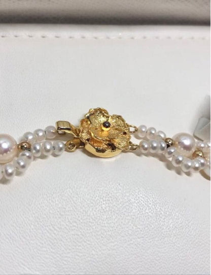 Akoya and freshwater pearl braided necklace with white pearls and silver clasp, approximately 43cm long