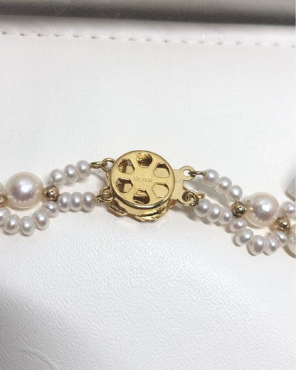 Akoya and freshwater pearl braided necklace with white pearls and silver clasp, approximately 43cm long