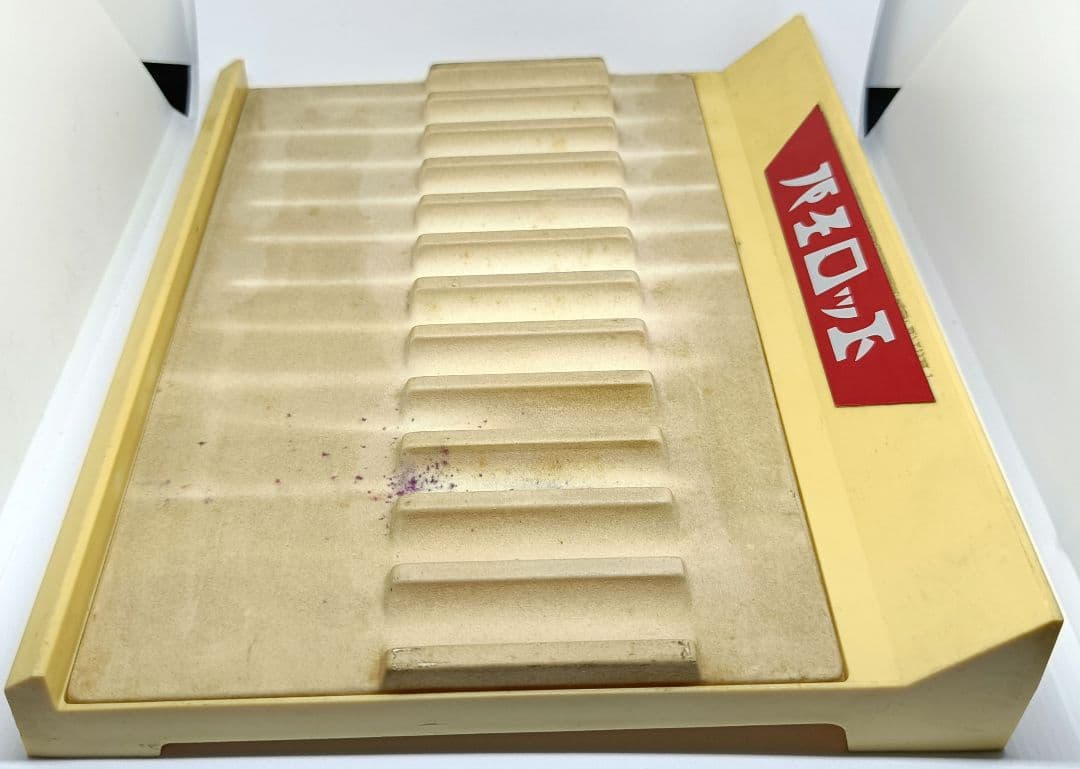White and red Pilot pen tray with sunburned and heavily stained surface