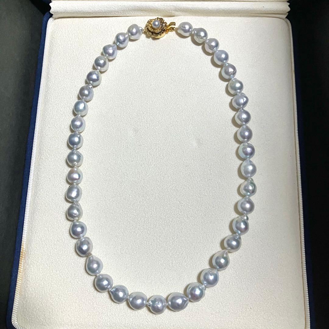 Akoya pearl necklace featuring large 9.0mm round pearls with gold hardware and flower-shaped clasp in blue-gray tone