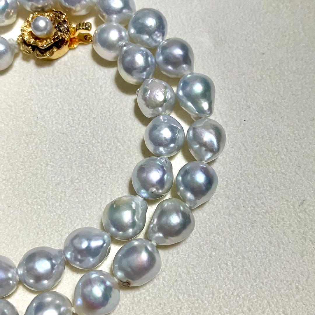 Akoya pearl necklace featuring large 9.0mm round pearls with gold hardware and flower-shaped clasp in blue-gray tone