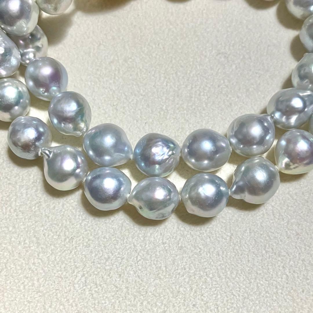 Akoya pearl necklace featuring large 9.0mm round pearls with gold hardware and flower-shaped clasp in blue-gray tone