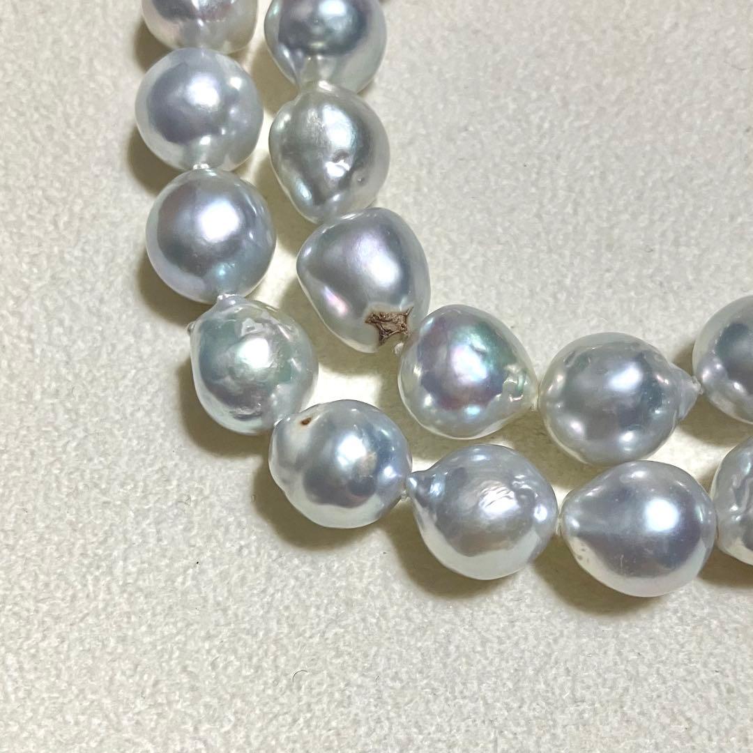 Akoya pearl necklace featuring large 9.0mm round pearls with gold hardware and flower-shaped clasp in blue-gray tone