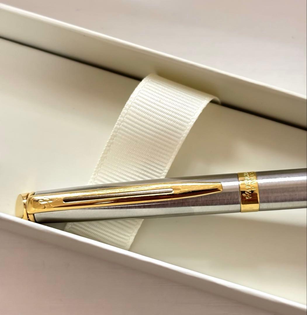 Waterman ballpoint pen with silver body and gold trim on a white background