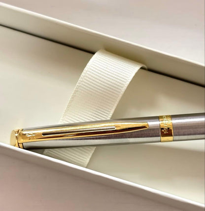Waterman ballpoint pen with silver body and gold trim on a white background