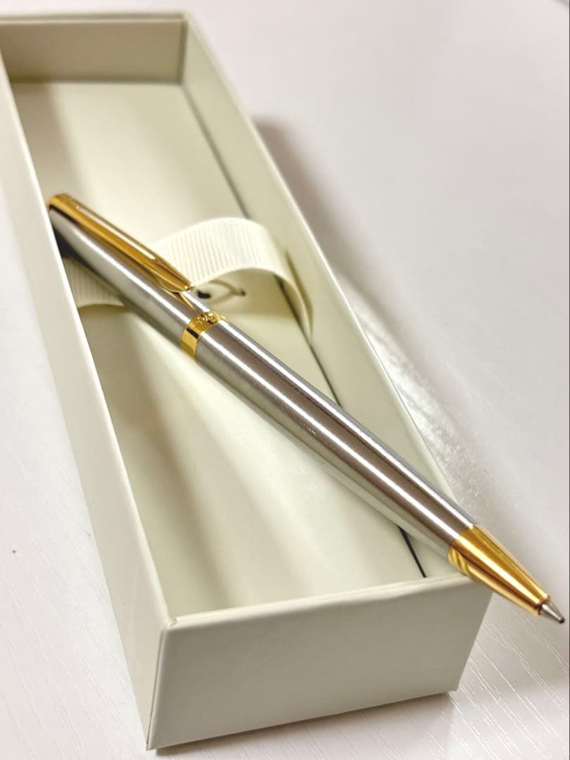 Waterman ballpoint pen with silver body and gold trim on a white background